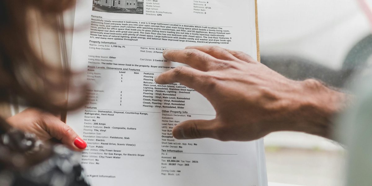 A person thoughtfully reviewing different property options and community guides, considering their lifestyle.