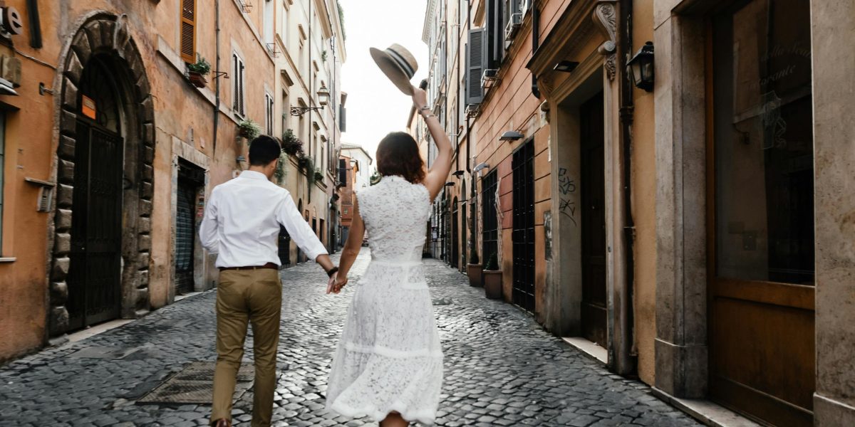A couple enjoying a stroll through a charming, historic city street, reflecting Montreal's unique European ambiance.