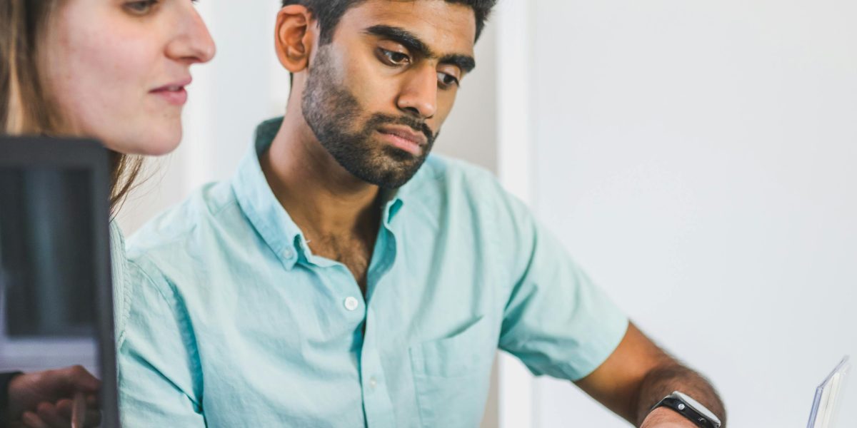 A financial advisor discusses confidential property acquisition strategies with a client.