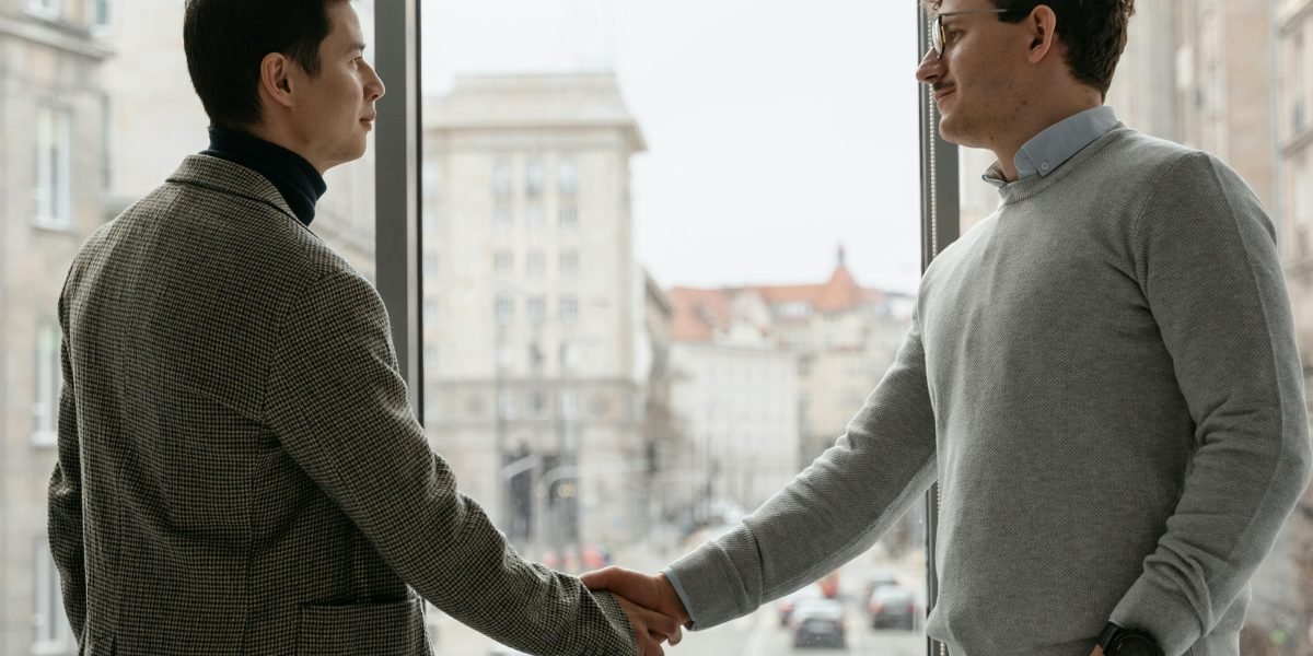 A private meeting between professionals to discuss an exclusive, off-market property deal.