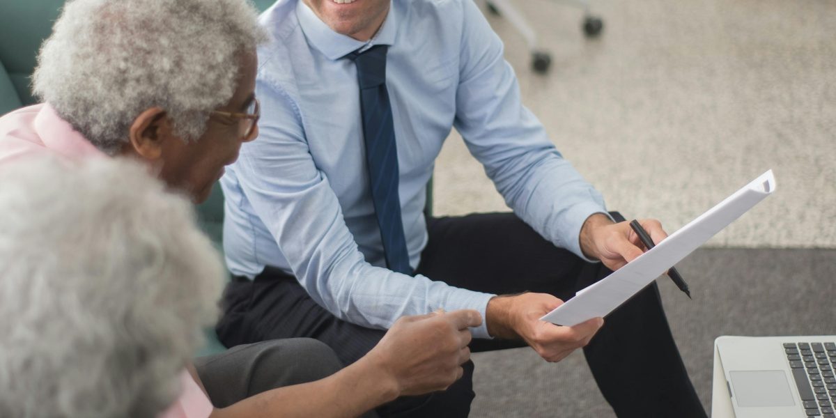 A person consulting with a financial advisor about mortgage options for property investment.