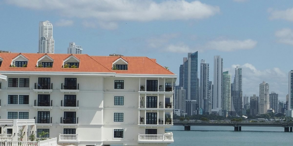 An international investor surveys a tranquil luxury property, envisioning a peaceful suburban life.
