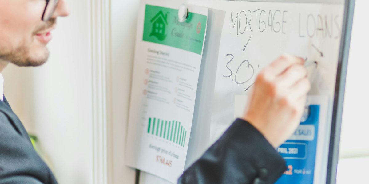 Professionals discussing real estate market data and trends for luxury properties.