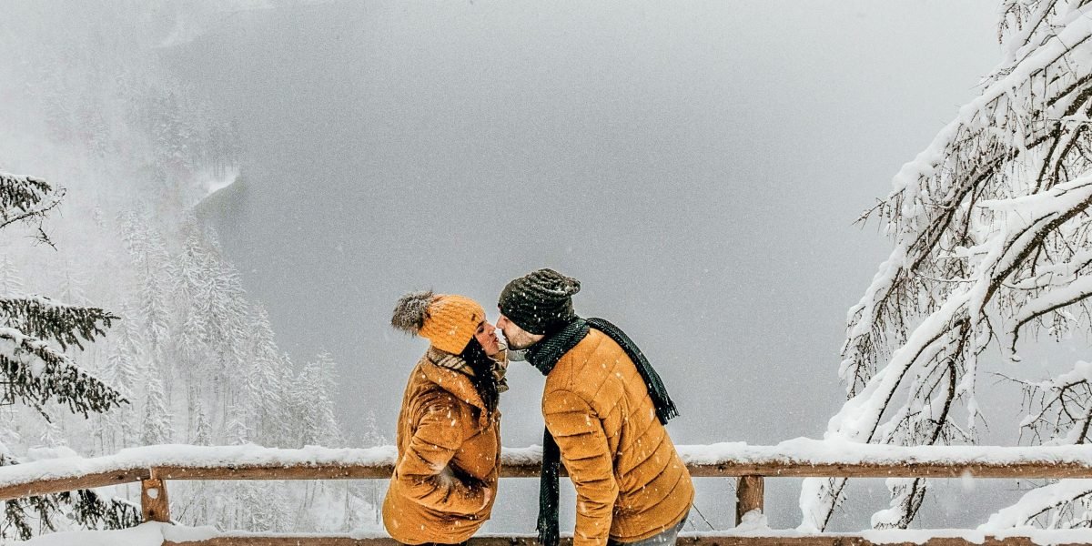 A couple enjoying a panoramic view from a spacious luxury property, embodying the desire for escape and beautiful surroundings.