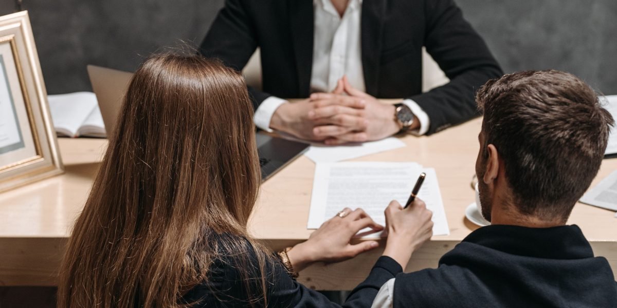 Professionals reviewing legal documents, representing the crucial due diligence in cross-border property transactions.