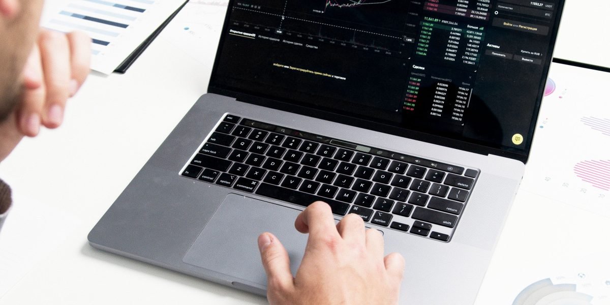 An investor reviews financial charts and global market data, planning strategic diversification across different regions.