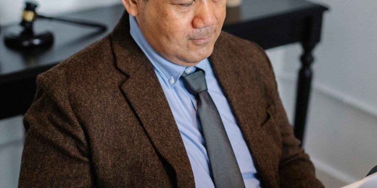 A person diligently reviewing complex documents, representing the crucial due diligence phase of property acquisition.