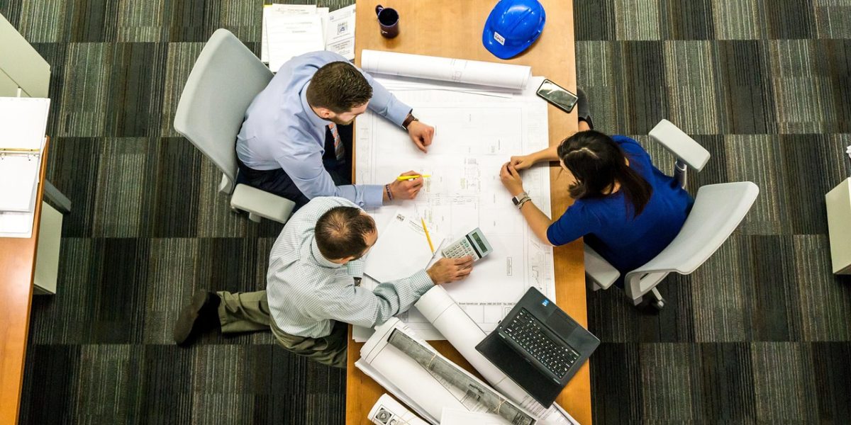 A team collaborates on a whiteboard, strategizing for future investments and risk management in a dynamic market.