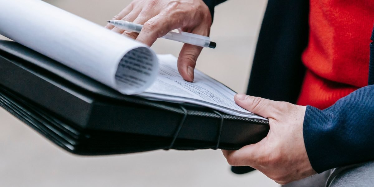 An investor carefully reviews documentation, considering opportunities in the dynamic UAE luxury real estate market.