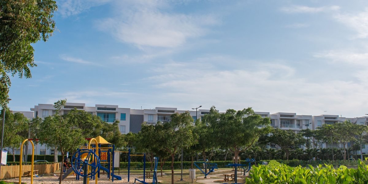 A family enjoys a leisurely stroll through a beautifully landscaped green park within a master-planned luxury community.
