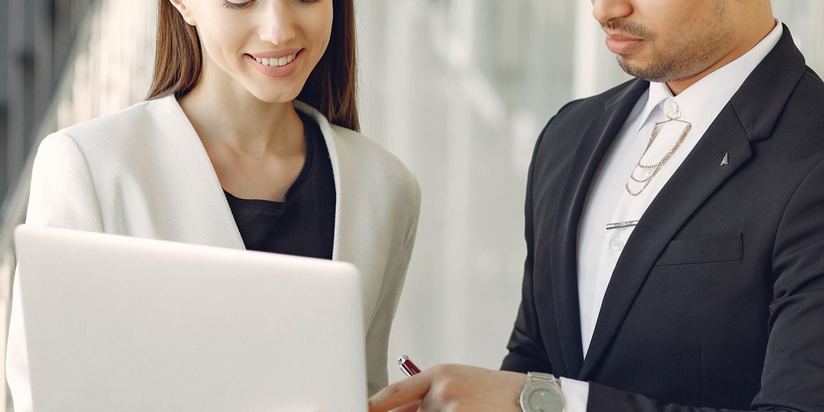 Two professionals discuss architectural plans or project details, emphasizing collaboration and precision.