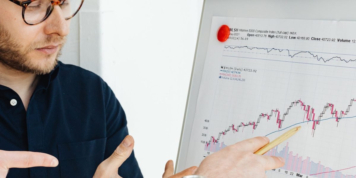 A trusted real estate advisor discusses investment goals with a client, emphasizing personalized service and understanding.