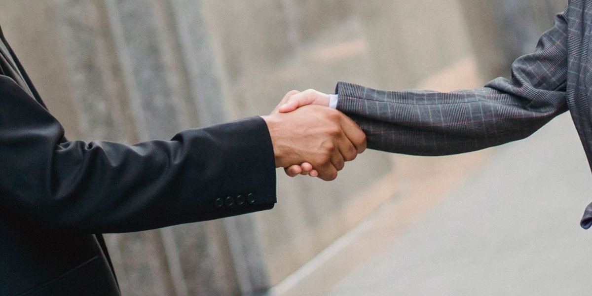 A handshake seals a successful deal or partnership between professionals in a high-stakes transaction.