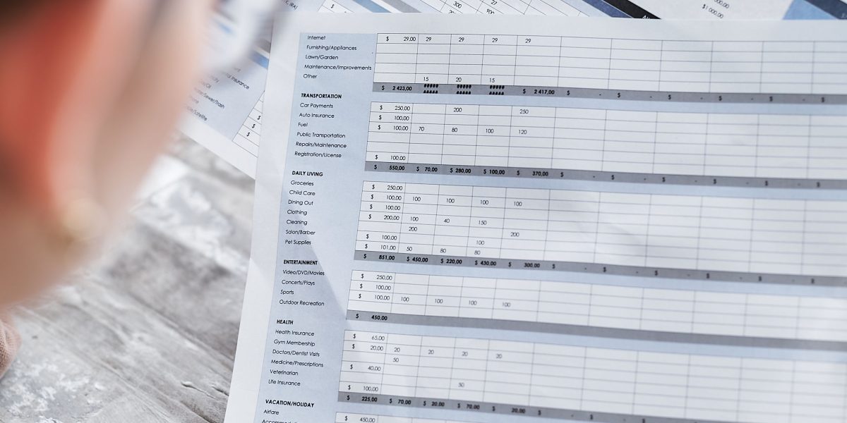 An individual carefully reviews legal and financial paperwork, ensuring due diligence for a complex investment.