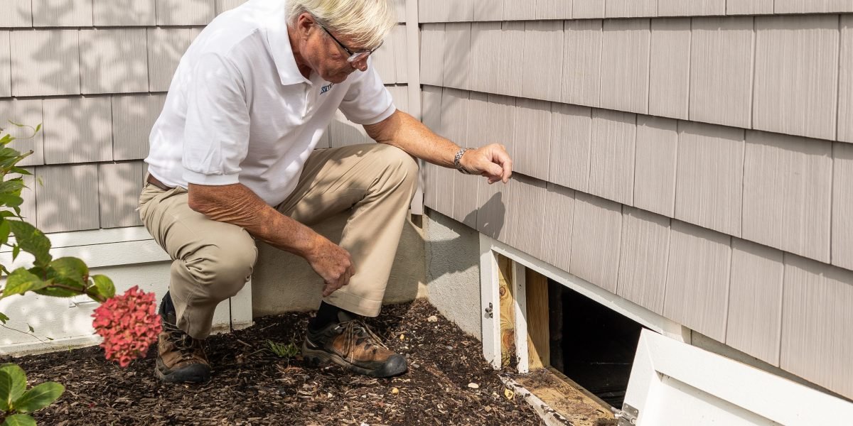 An expert appraiser meticulously examining the unique architectural details of a mid-century modern residence.