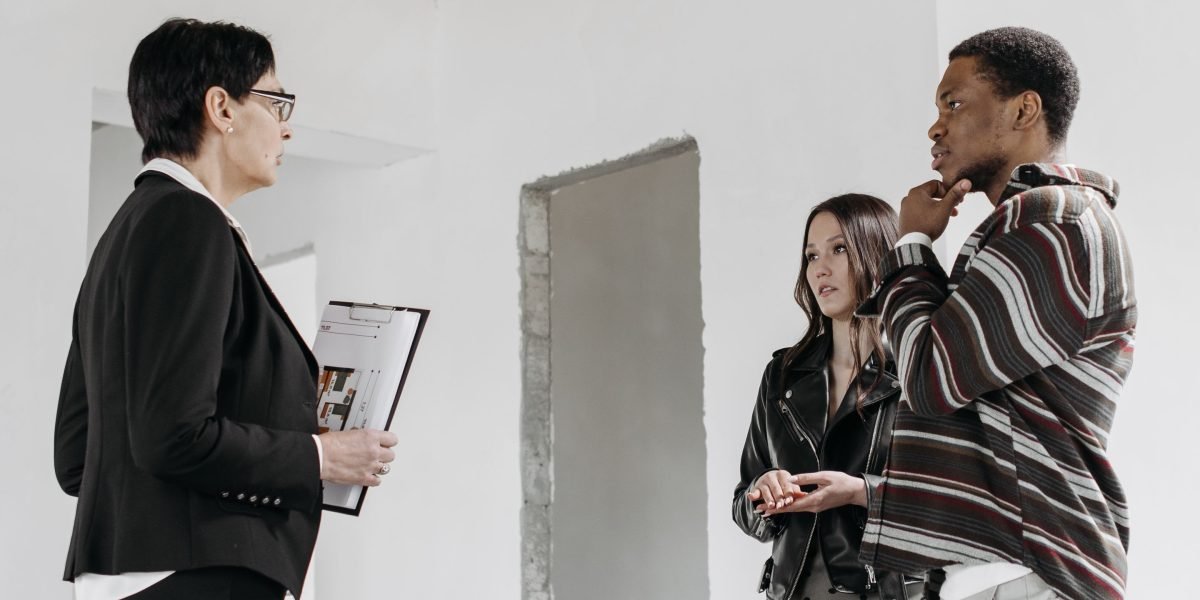 A couple discussing their preferences and plans for a new luxury home, focusing on lifestyle and location.