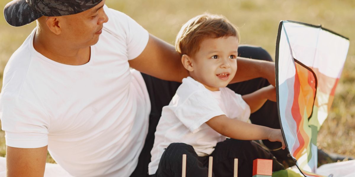 A family enjoying outdoor activities in a lush, green park, highlighting the family-friendly nature of Emirates Hills.