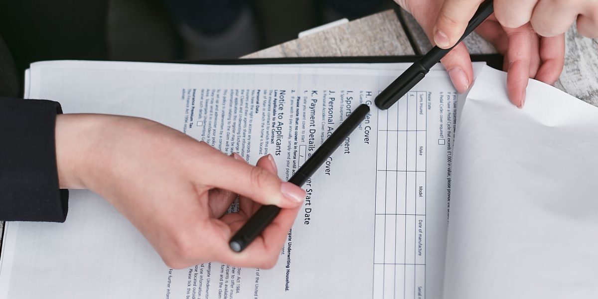 Investors carefully reviewing legal and financial documents to protect their property investments.