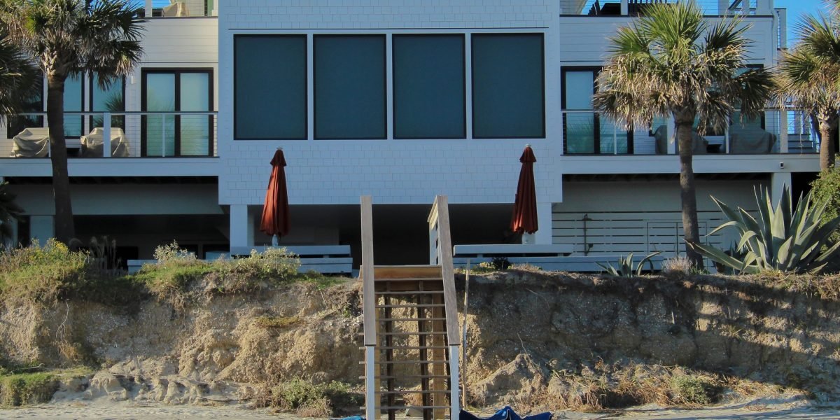 A serene scene depicting a luxurious waterfront property, highlighting the unique value and privacy of island and coastal homes.