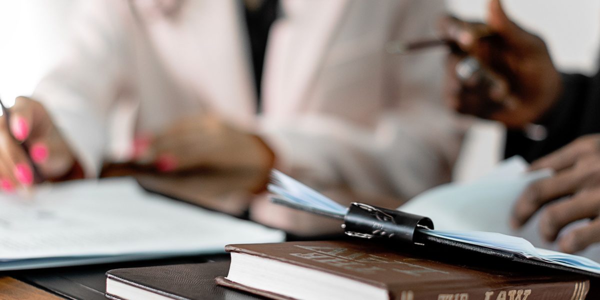 Professionals collaborate on reviewing legal documents and contracts, ensuring thorough due diligence for complex property transactions.